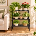 3 step black metal plant stand with potted plants in a living room